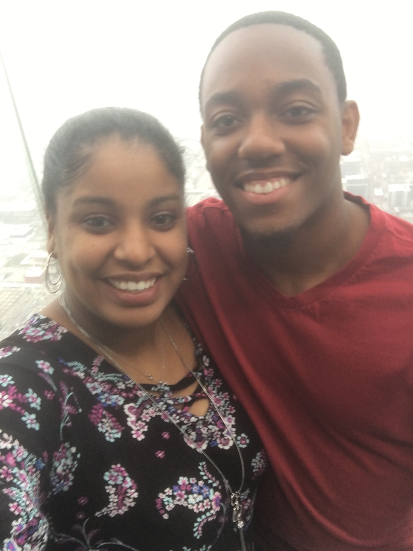 Gabriella and Tremayne smiling together high above the city skyline