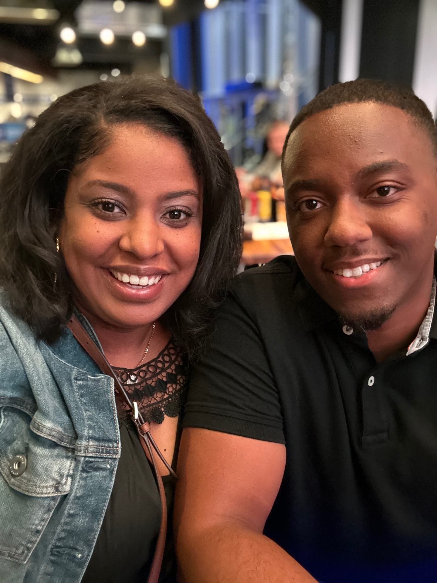 Gabriella and Tremayne smiling together at dinner